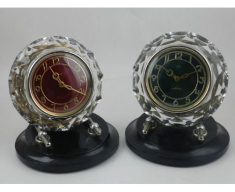 A late 20th Century Russian mantle timepiece, the red dial set out with Arabic numerals with in a faceted clear glass surroun