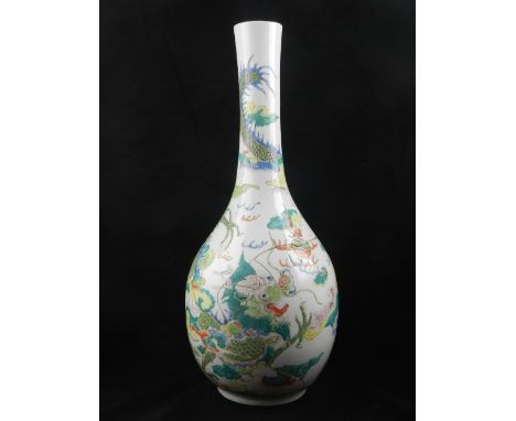 A late 19th century Chinese ceramic vase, of ovoid form with elongated neck, decorated in the famille vert palette with a dra