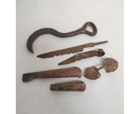 collection of medieval to post medieval wrought iron tools to include a medieval iron bale hook, two knife blades and an iron