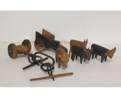 Vintage African carved hardwood figures depicting a team of oxen pulling a wagon. 