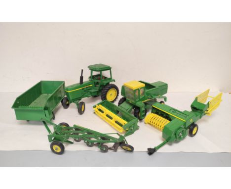 Five vintage ERTL USA die-cast John Deere agricultural toys to include a Combine Harvester, Plough, Tractor etc. (5) 