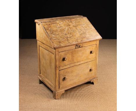 A 19th Century Painted Pine County Bureau. The sloped front rising to access four small internal drawers with a turned wooden