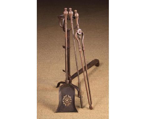 A Set of 19th Century Iron Fire Tools: A Poker, Tongs and Shovel with pierced pan, on finialed baluster handles.