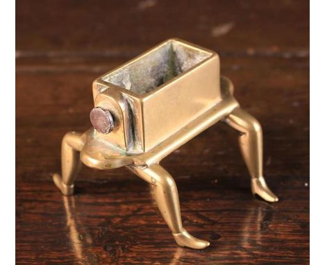 A Rare Late 18th Century Brass Pen-nib Washer having a rectangular trough with screw-clamp fastener to one end, standing on f