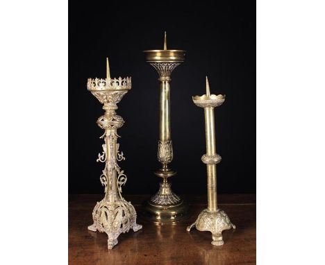 Three Large 19th Century Cast Brass Pricket Candlesticks: One Neo-Gothic with elaborately cast ornamentation standing on a pi