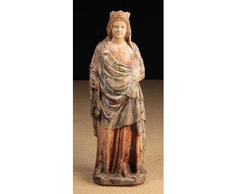 A 14th Century Carved &amp; Polychromed Stone Statue of Madonna (A/F). The figure depicted wearing a crown over a head-scarf 