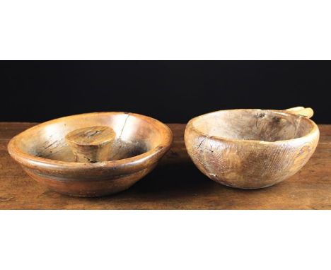 A 19th Century Dug-out Treen Bowl with a funneled spout and wire staple repairs, 4" (10 cm) high, 8½" (22 cm) wide, 12" (30.5