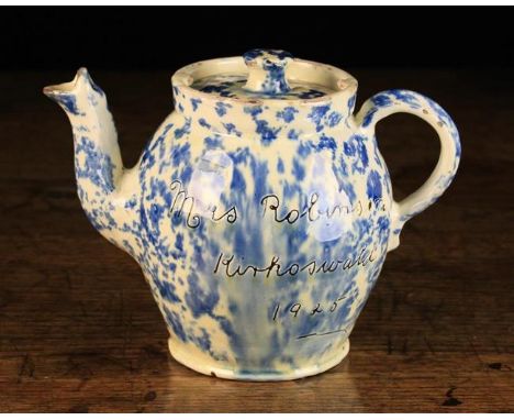 A Wetherigg's Pottery Teapot with stippled blue glaze on a cream glazed ground and sgrafitto inscription 'Mrs Robinson Kirkos