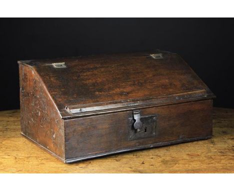 An 18th Century Boarded Oak Desk Box. The sloped lid with applied book ledge moulding, opening to reveal a bank of three draw