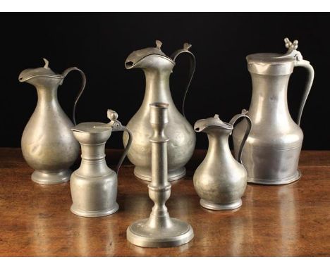 Five Pewter Measures and a Pewter Candlestick: To include a graduated set of three baluster ewers with hinged lids stamped 'D