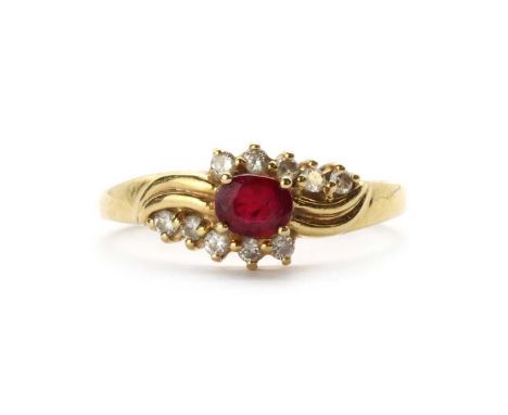 A gold ruby and diamond ring,an oval mixed cut ruby, claw set, an outer row of brilliant cut diamonds, claw set either side, 