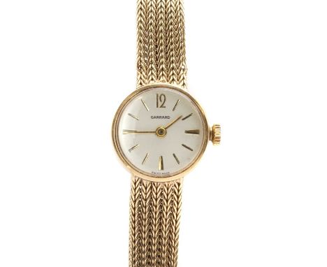 A ladies' 9ct gold Garrard mechanical bracelet watch,a round case, 17mm diameter, with a silvered dial, gilt baton hour marke