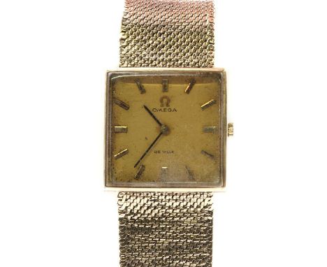 A 9ct gold Omega mechanical bracelet watch, a square case, 26mm diameter, with baton hour markers and black hands, to an inte