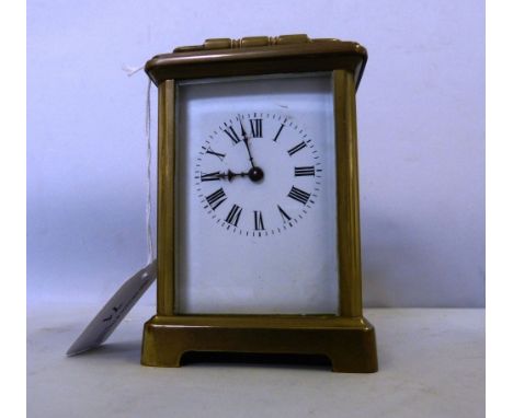 AN early 20th century brass carriage clock with white enamel dial