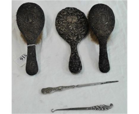 Two Silver Backed Brushes, a hand mirror, button hook and letter opener, c.800grams 