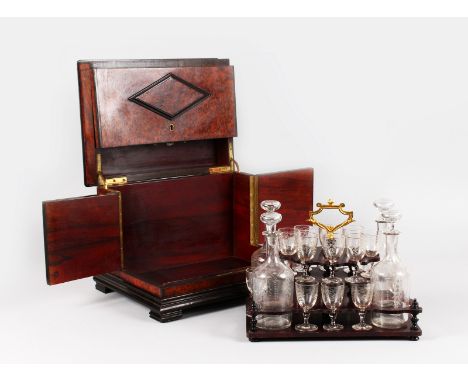 A GOOD FRENCH TRAVELLING LIQUEUR DECANTER SET, comprising sixteen glasses and four decanters.  14ins wide.