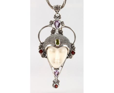 A SILVER ART NOUVEAU DESIGN FEMALE HEAD PENDANT AND CHAIN set with garnets, amethysts and peridot.