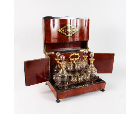 A VERY GOOD FRENCH CASED DECANTER SET with lift up lid opening to reveal four decanters & stoppers and sixteen glasses with g