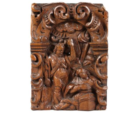 A SMALL 17TH CENTURY OAK CARVING, two figures in an arch surrounded by scrolls. 11ins x 7.5ins.