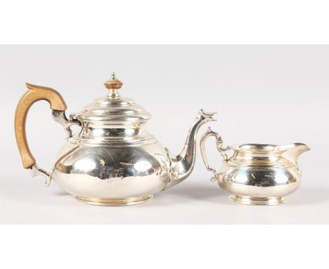 A QUEEN ANNE DESIGN TEAPOT AND MILK JUG. London 1937.  Retailed by HARRODS.  Weight 30ozs.