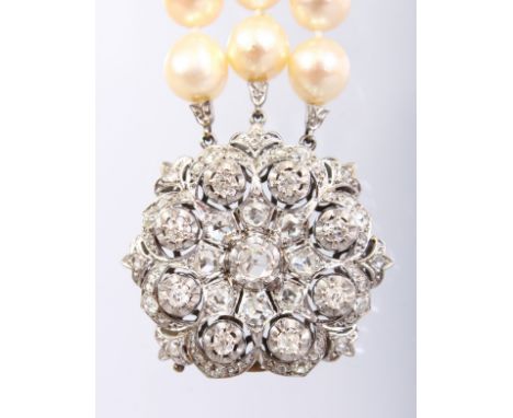 A SUPERB TRIPLE ROW PEARL NECKLACE with large white gold and diamond clasp.