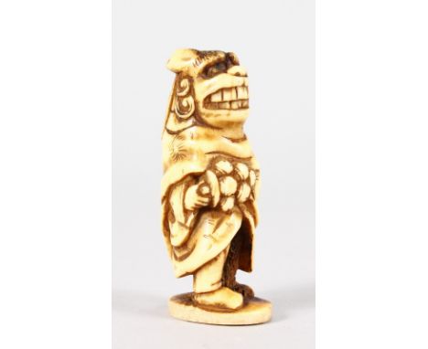 A CHINESE GROTESQUE FIGURE CARVED STAG ANTLER NETSUKE.