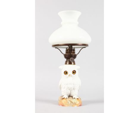 A CONTINENTAL WHITE PORCELAIN OWL LAMP BASE with glass eyes, complete with white shade. Owl 6.5ins high.
