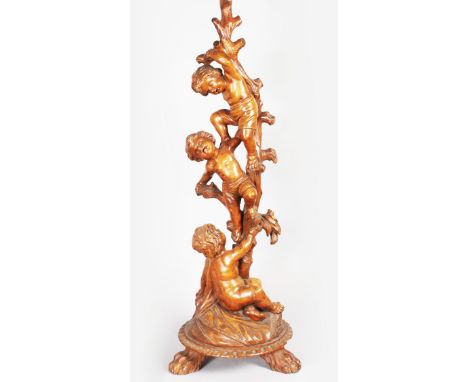 A SUPERB 18TH-19TH CENTURY ITALIAN CARVED WALNUT STANDARD LAMP with three cupids climbing a tree, on a circular base with thr