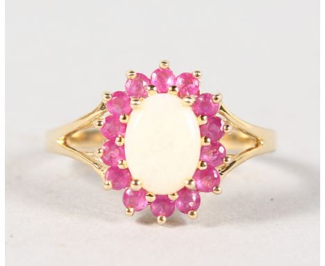 A 9CT GOLD, OPAL AND RUBY DRESS RING.