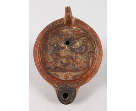 TERRA COTTA ROMAN OIL LAMP, 5ins long, the top with figures and a dog.
