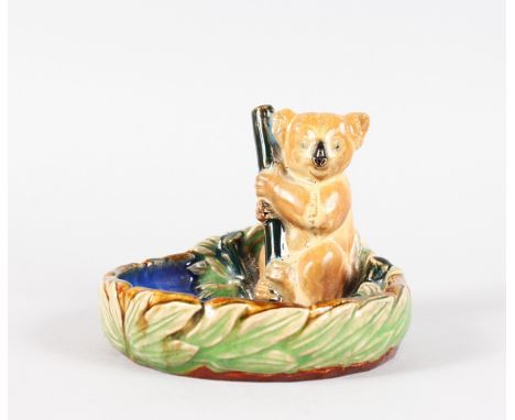 A ROYAL DOULTON STONEWARE ASHTRAY as a koala holding a stick with blue interior. 5.5ins diameter.  No. 8902 7141.