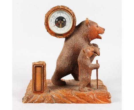 A BLACK FOREST CARVED WOOD BEAR GROUP, a large bear carrying a barometer on his back, a small bear by his side. 14ins high x 