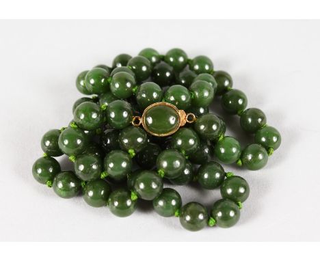 A STRING OF JADE BEADS.