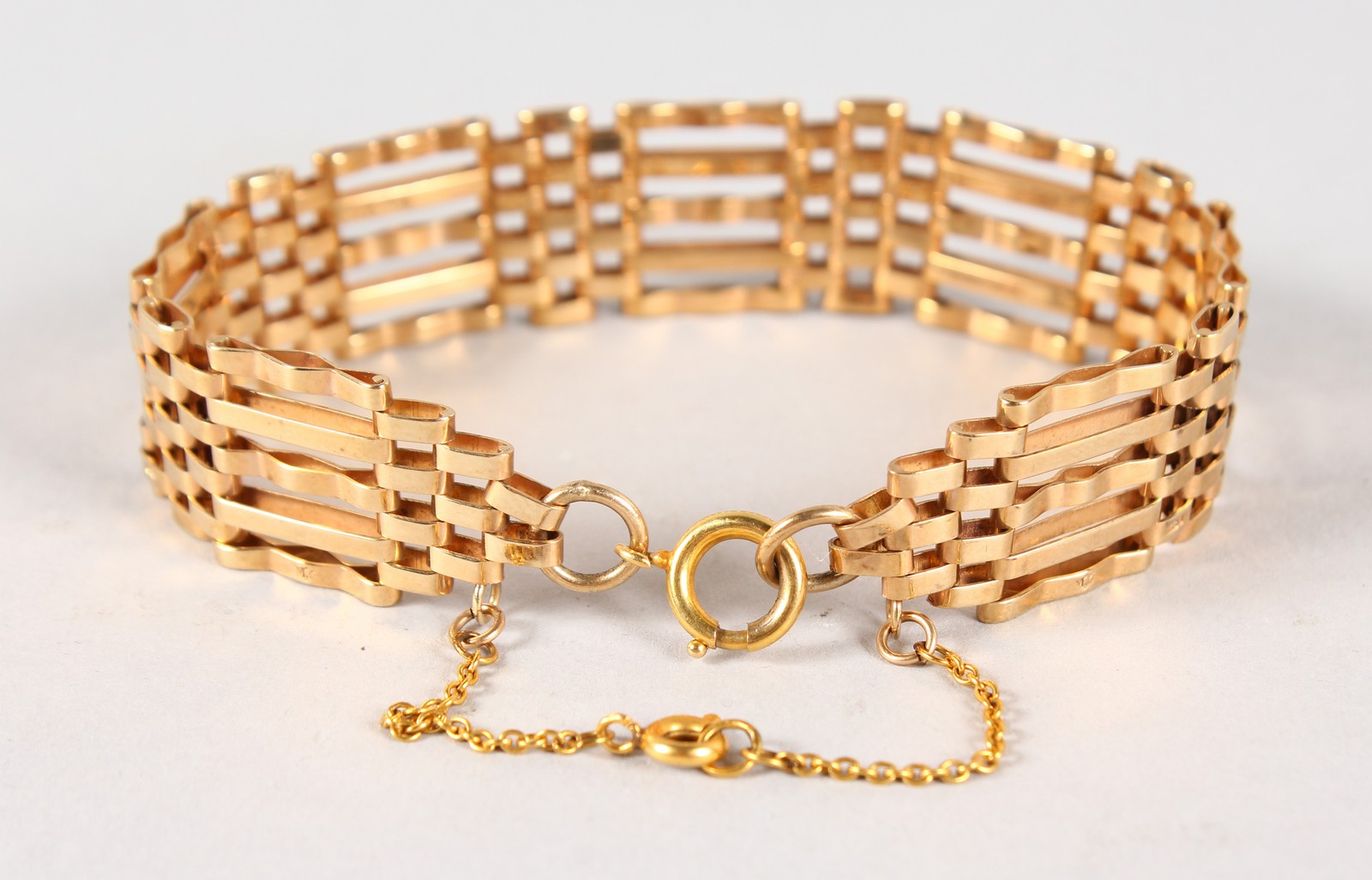 A 9CT GOLD GATE BRACELET, 16gms.