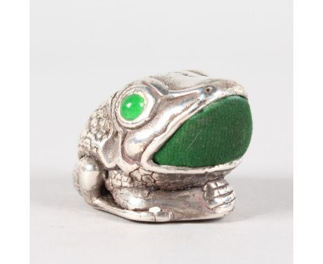 A SILVER NOVELTY FROG PIN CUSHION with jade eyes.