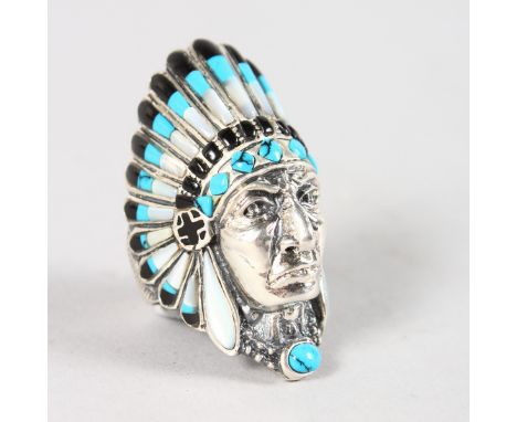 A SILVER INDIAN HEAD RING decorated with turquoise and enamel.