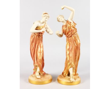 A GOOD PAIR OF ROYAL WORCESTER WHITE AND GILT PORCELAIN CLASSICAL FIGURES OF YOUNG LADIES, one playing a musical instrument, 