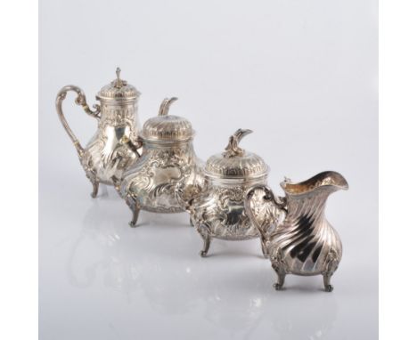 A continental white metal four piece tea set, fluted baluster body with repousse chased scrolls around vacant cartouche, each