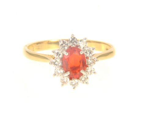 A Mexican fire opal and diamond oval cluster ring, the oval mixed cut opal 7mm x 5.10mm x 2.97mm, claw set and surrounded by 