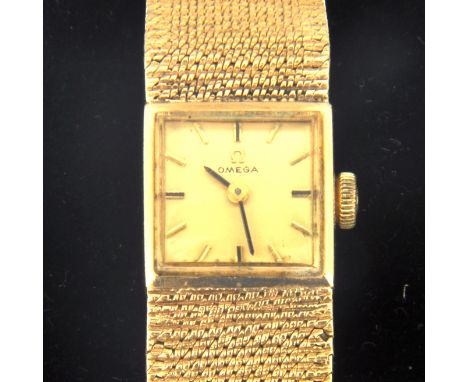 Omega - A ladies 9 carat yellow gold bracelet watch, rectangular champagne baton dial in a 9 carat yellow gold case with inte