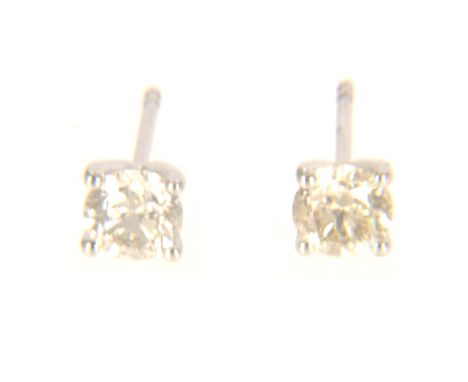 A pair of diamond single stone earrings, one brilliant cut diamond four claw set to each, in all white metal mounts stamped 7