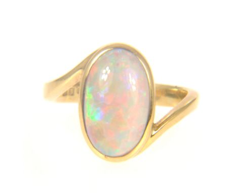 An opal dress ring, an oval cabochon cut opal 14mm x 8mm, collet set in an 18 carat all yellow gold closed back mount, 3.3mm 