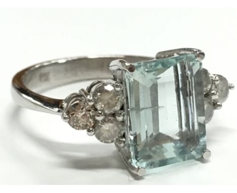 An 18 carat white gold aquamarine and diamond ring, size R.