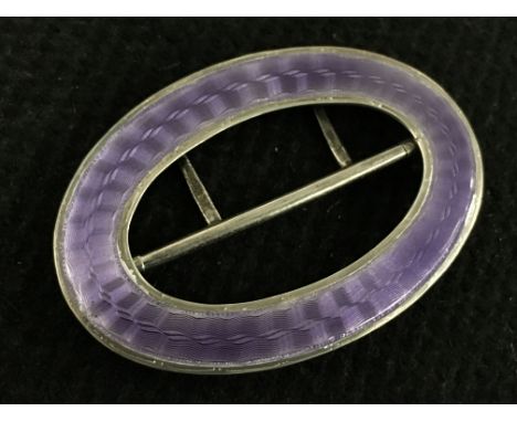 A silver and purple enamel Liberty and Co oval shaped belt buckle.