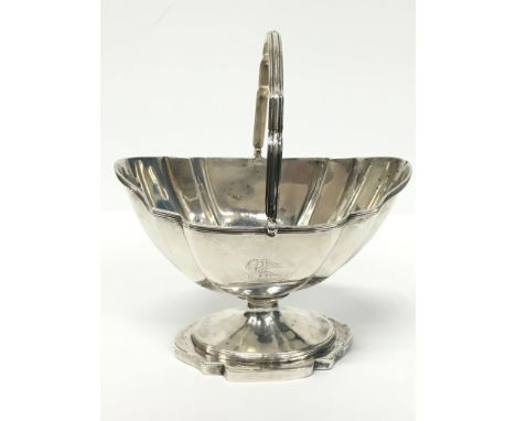 A Georgian silver helmet shaped basket with swing handle (277 grams).
