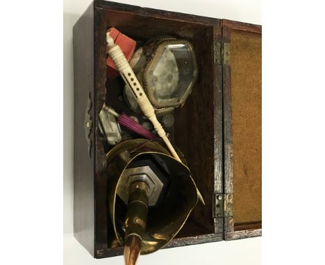 A 19th century rosewood tea caddy containing various collectables including two ivory stanhopes, silver 3D coins, Trench Art 