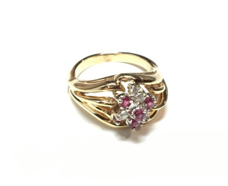 A diamond and ruby cluster ring, size O.