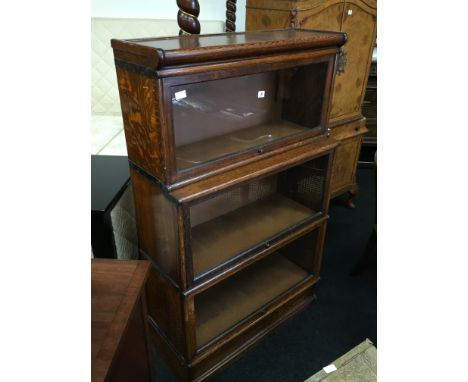 A Globe Wernicke style three section glazed oak bookcase (replacement hardboard back, otherwise OK).