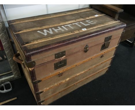 A canvas covered travel trunk with fitted interior by M. Lambert, Cannes with leather carrying handles.