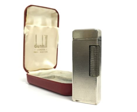 An engine turned Dunhill silver plated cigarette lighter in original presentation case.